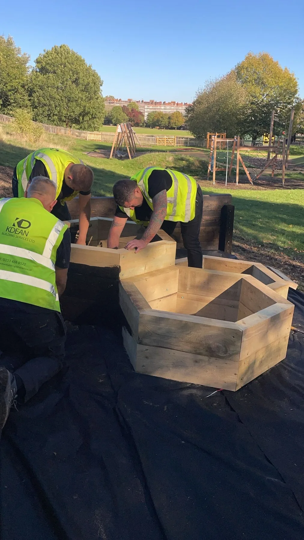 K Dean operatives assembling the hexagonal timber planters at the Adventure Playground