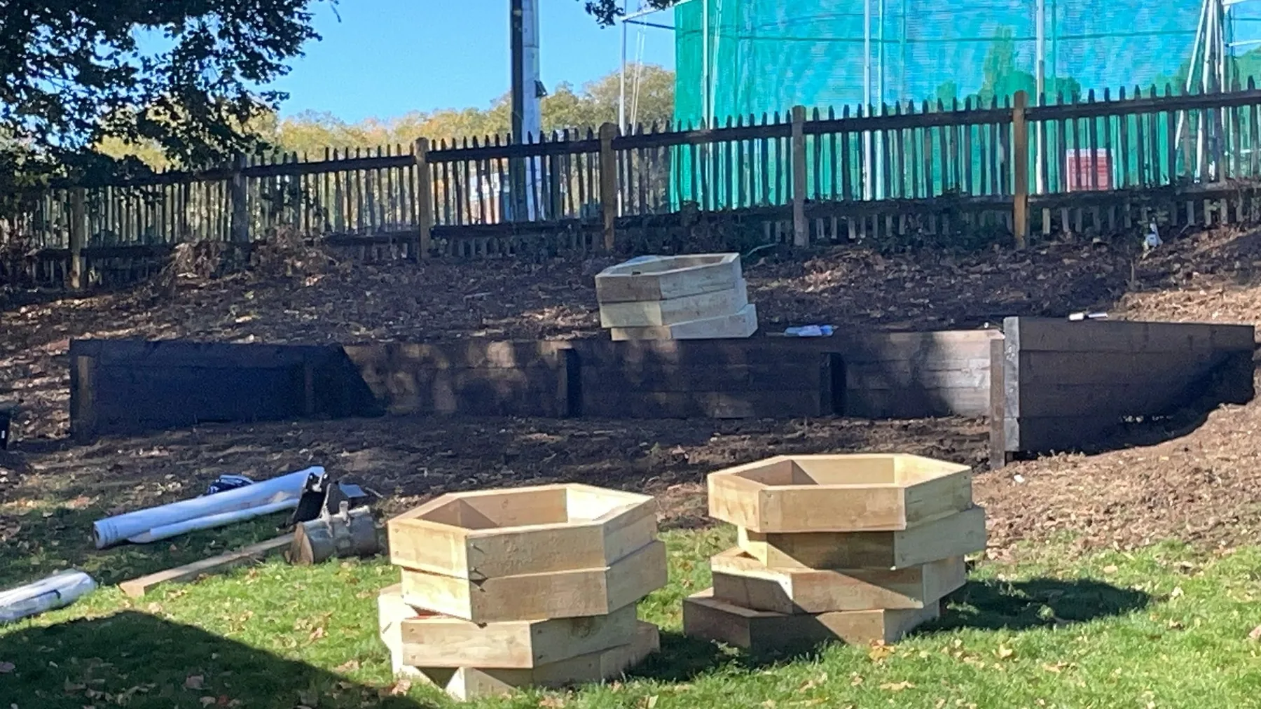 Timber hexagonal planter components prepared for installation at the Adventure Playground