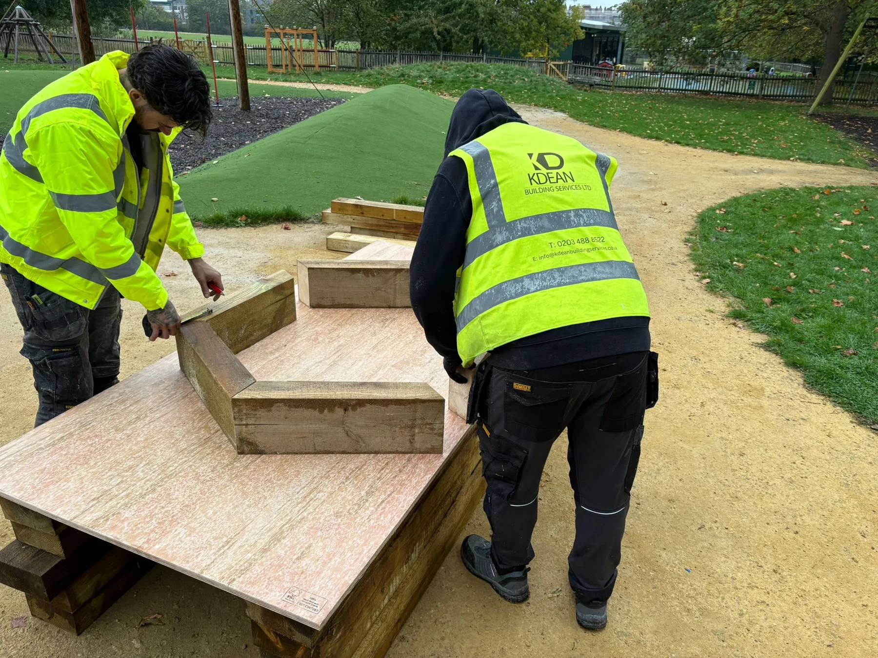 K Dean operatives measuring and setting out timber components for the Adventure Playground raised planters